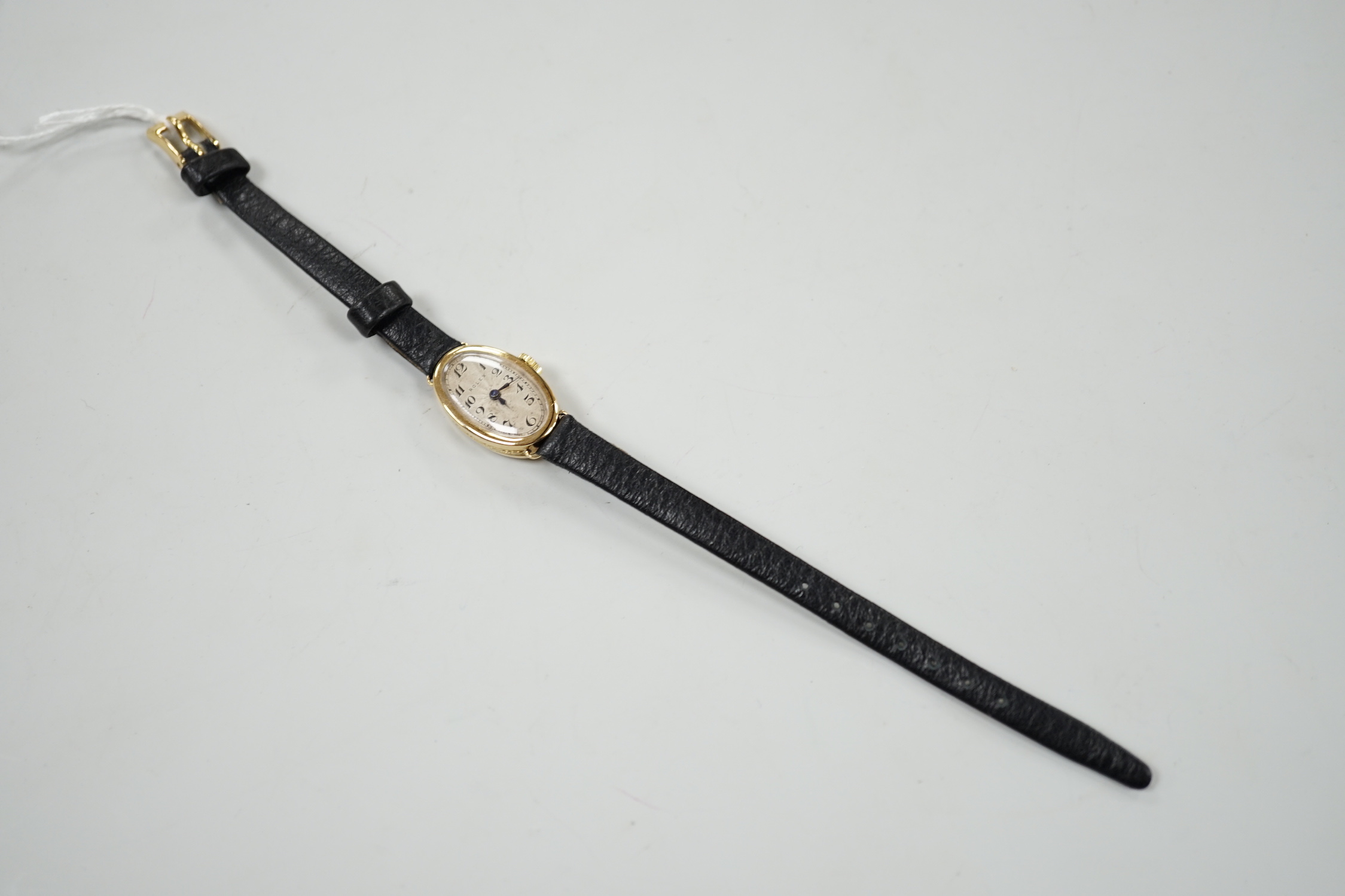 A lady's 1930's 18ct gold oval Rolex manual wind wrist watch, with Roman dial and Rolex Prima movement, with engraved inscription and associated strap, with service receipt.